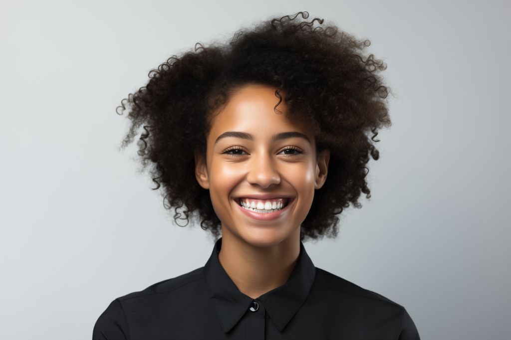 Studio portrait of smiling 20yo african woman in black top