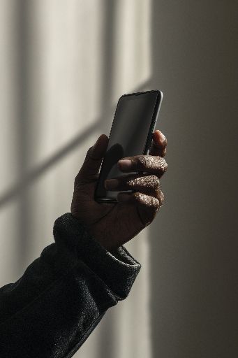 hand holding smartphone, soft lighting, close-up shot.