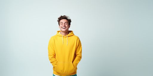 smiling 20-year-old boy in yellow hoodie - clean studio shot