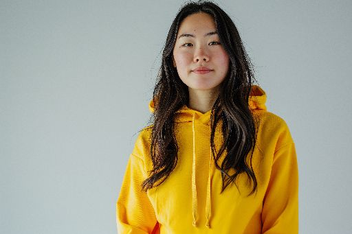Confident young woman in a vibrant yellow hoodie