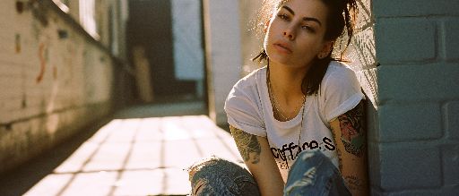A young woman outdoors wearing a embroidered t-shirt with patches